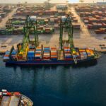 Home Aerial shot of colorful shipping containers at North Jakarta's bustling port, Indonesia.